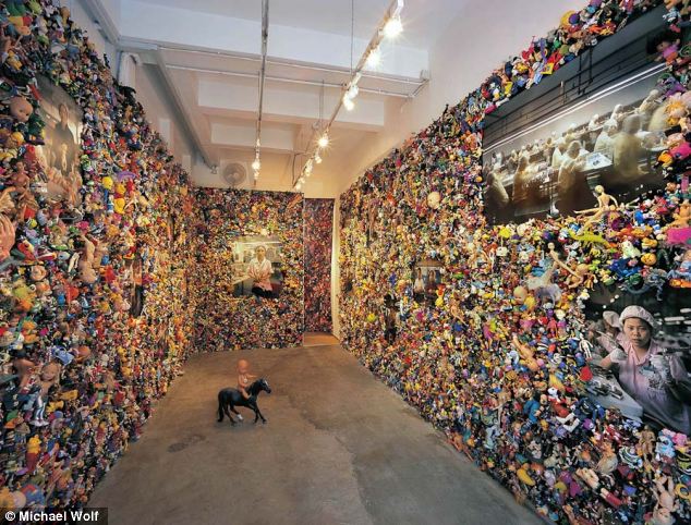 Wolf decided to exhibit his photographs surrounded by 16,000 second hand toys that he bought from flea markets in California